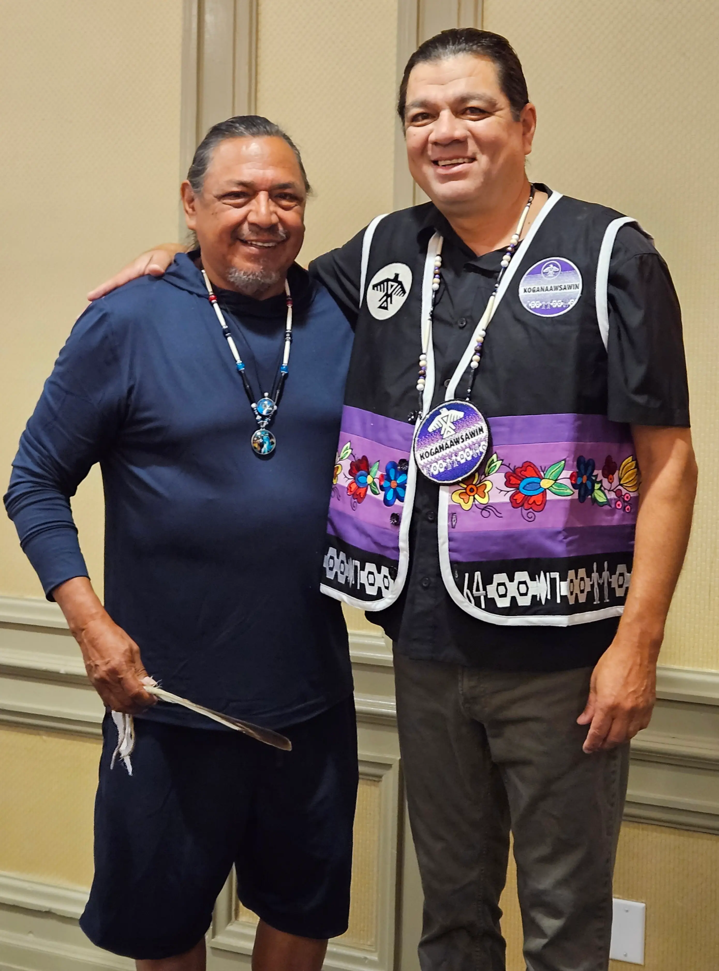 Getzit Mike Esquega gifts Duke Peltier with a floral vest and beaded medallion to honour his role as the Anishinabek Nation Children’s Commissioner.